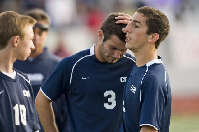 Corona del Mar's Jack Gorab, right, consoles Brian Ford (3) after losing to Paramount during a CIF Southern Section Division III semifinal game at Paramount High.