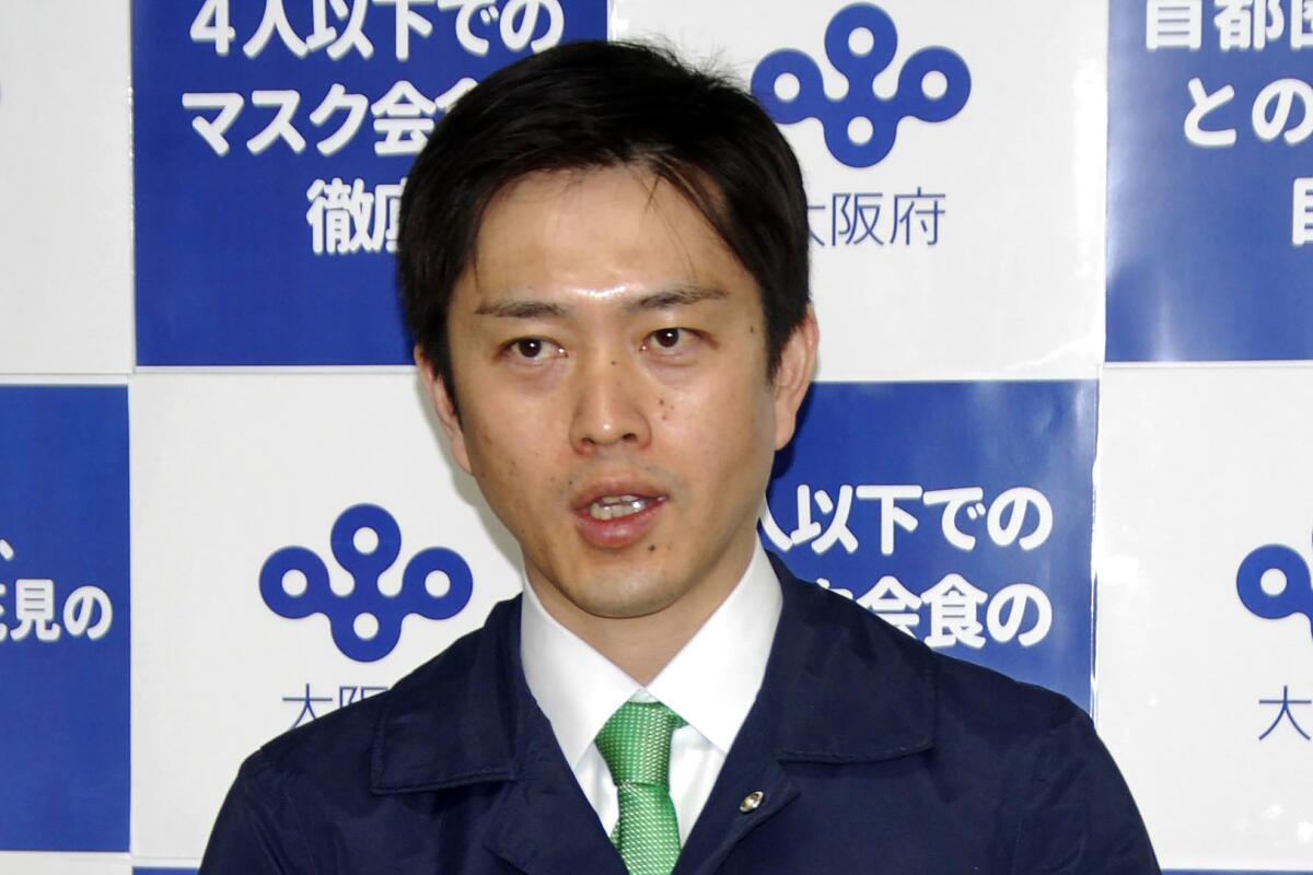 Osaka Gov. Hirofumi Yoshimura speaks to reporters in Osaka, western Japan Thursday, April 1, 2021. Yoshimura said on Thursday that he wants to cancel the Olympic torch relay legs going through Osaka later this month. (Kyodo News via AP)