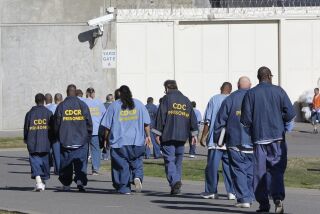 FILE - In this Feb. 26, 2013, file photo, inmates walk through the exercise yard at California State Prison Sacramento, near Folsom, Calif. Public interest attorneys filed an emergency motion, Wednesday, March 25, 2020, asking federal judges to free thousands of infirm and lower-security California prison inmates to prevent a spread of the coronavirus. (AP Photo/Rich Pedroncelli, File)