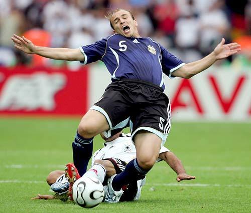Esteban Cambiasso of Argentina is tackled today by David Odonkor of Germany during the FIFA World Cup quarter-final match between Germany and Argentina at the Olympic Stadium in Berlin.