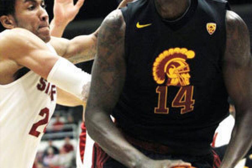 Dewayne Dedmon, right, has been suspended indefinitely from the USC men's basketball team.