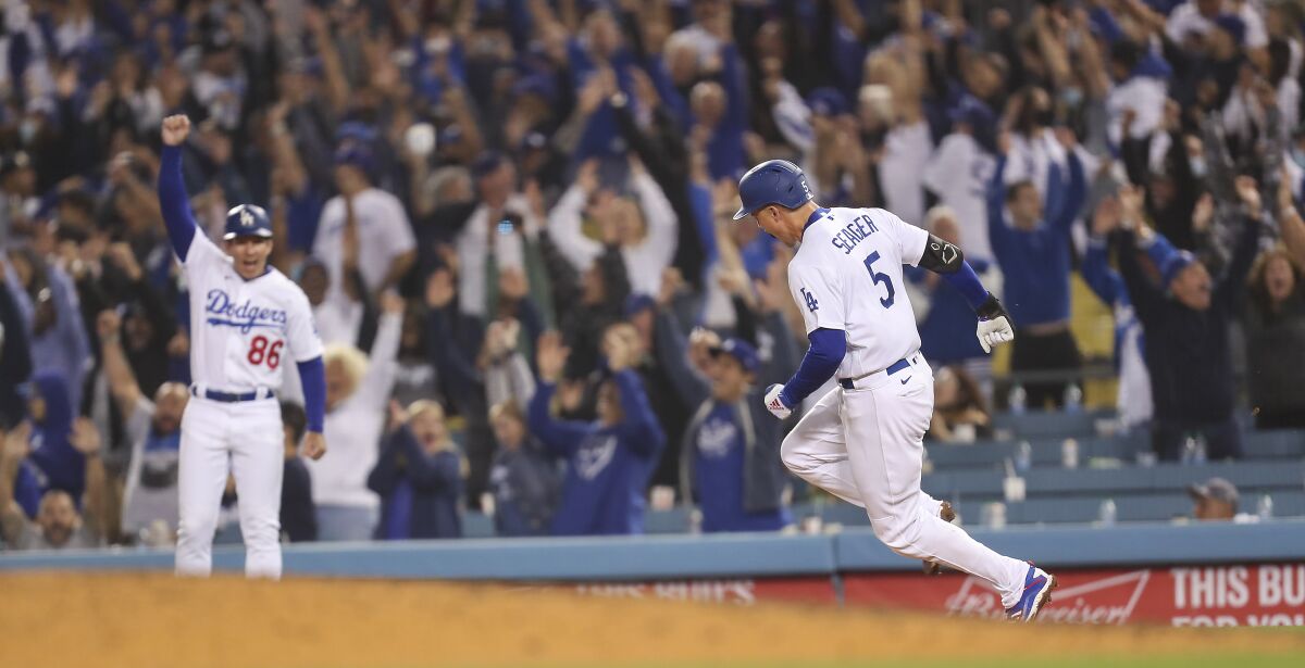 Dodgers' Corey Seager rounds the bases as he celebrates his go-ahead two-run home run.