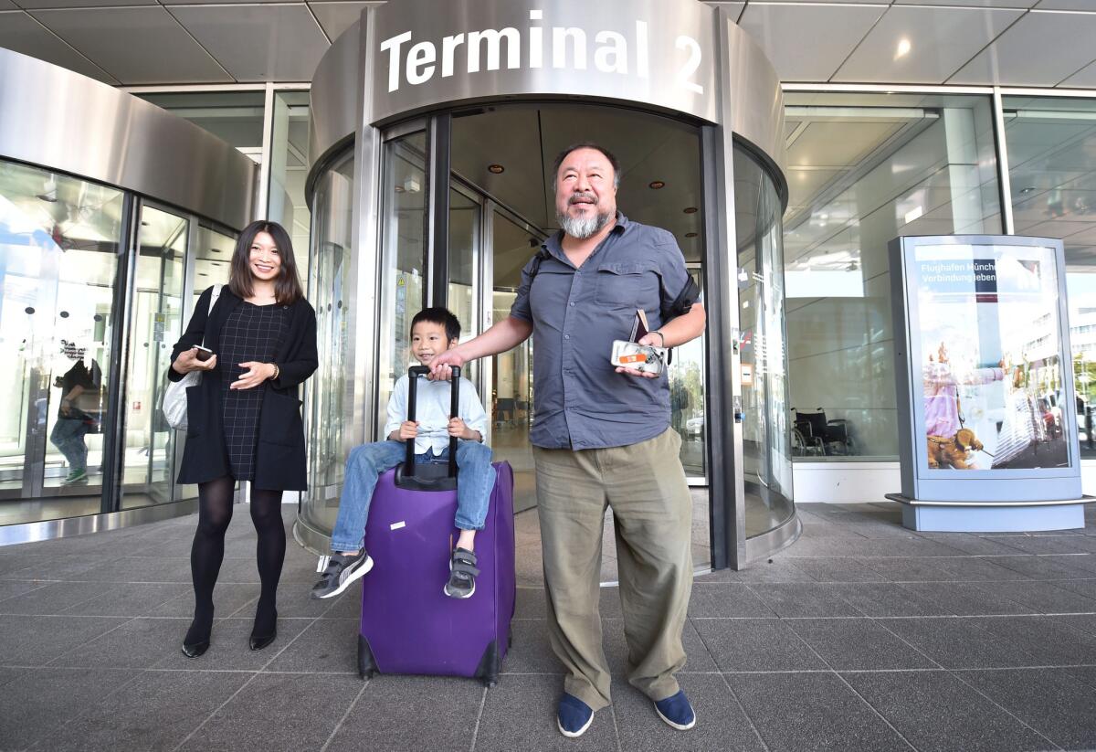 Chinese artist and critic of the Chinese regime Ai Weiwei arrives from Beijing at Munich Airport in Germany with his son Ai Lao and partner Wang Fen on July 30.