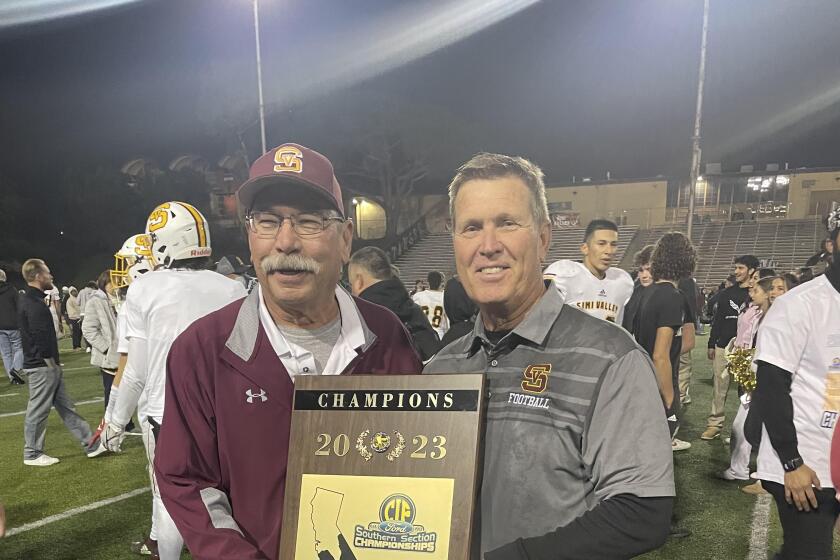 Simi Valley coach Jim Benkert (right) with his longtime assistant Richard Fong after his team won the Southern Section Division 6 championship
