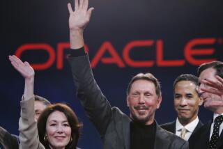 Oracle CEO Larry Ellison, center, smiles with Oracle CFO Safra Catz, left, and Oracle president Charles Phillips, second from right, during the Oracle Open World conference in San Francisco, Wednesday, Oct. 25, 2006. Oracle Corp. is scheduled to report fiscal second-quarter earnings after the bell. (AP Photo/Paul Sakuma)