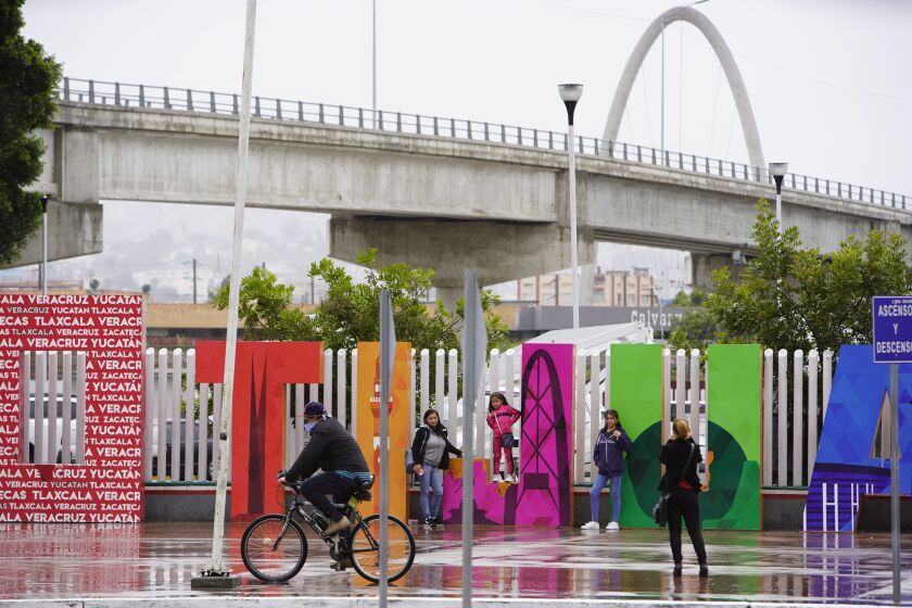 Tijuana, Baja California, Mexico April 7th, 2020 | Closed because of coronavirus restrictions, the now-empty square in front of the El Chaparral border crossing is abandoned. A family of stops by to take some photographs in the empty square. | (Alejandro Tamayo, The San Diego Union Tribune 2020)
