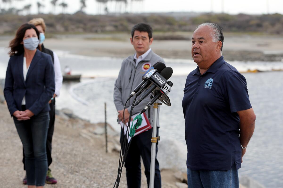 John Villa, right, the Huntington Beach Wetlands Conservancy executive director, speaks during a press conference Wednesday.