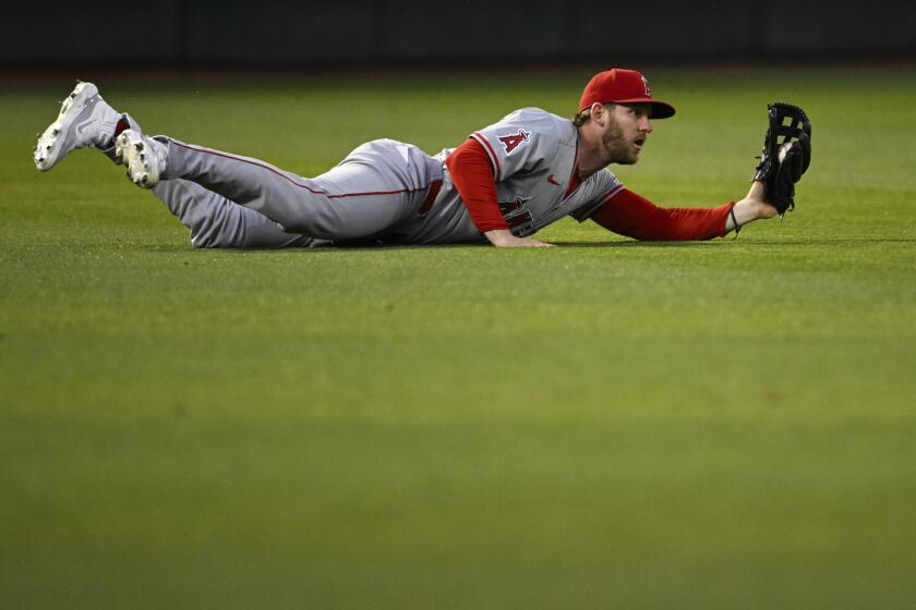 Los Angeles Angels outfielder Taylor Ward (3) makes a diving catch against the Oakland Athletics during the sixth inning of a baseball game Tuesday, July 2, 2024, in Oakland, Calif. (AP Photo/Eakin Howard)