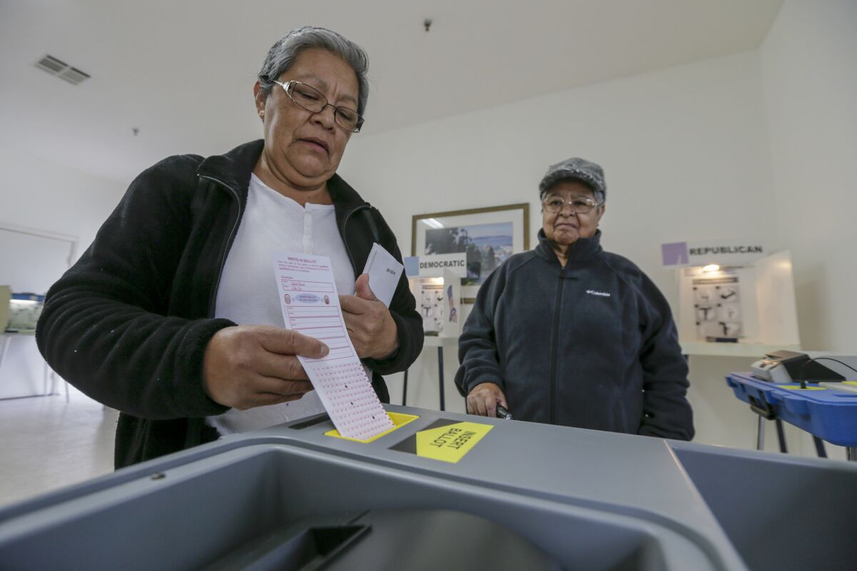 Amanda Compos, 61, left, and her mother Maria Bajan, 82, after casting their ballot at Curry Temple Christian Methodist Episcopal Church on June 7 in Compton.