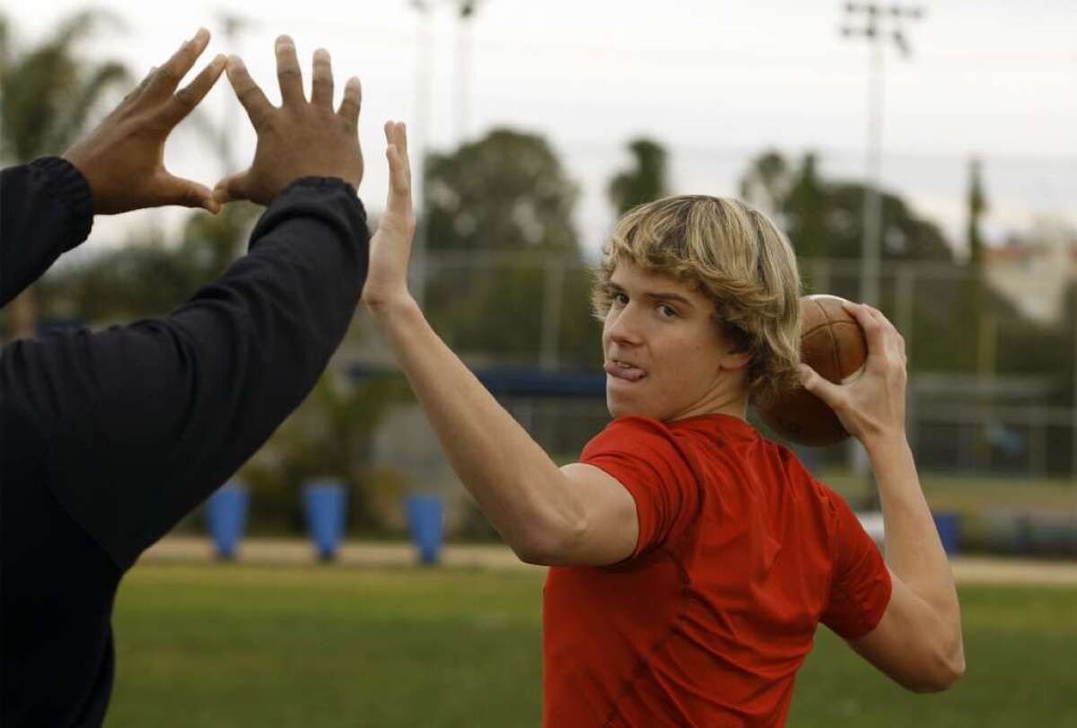 David Sills, then 15, works out with quarterback coach Steve Clarkson at Venice High School on Dec. 17, 2011.