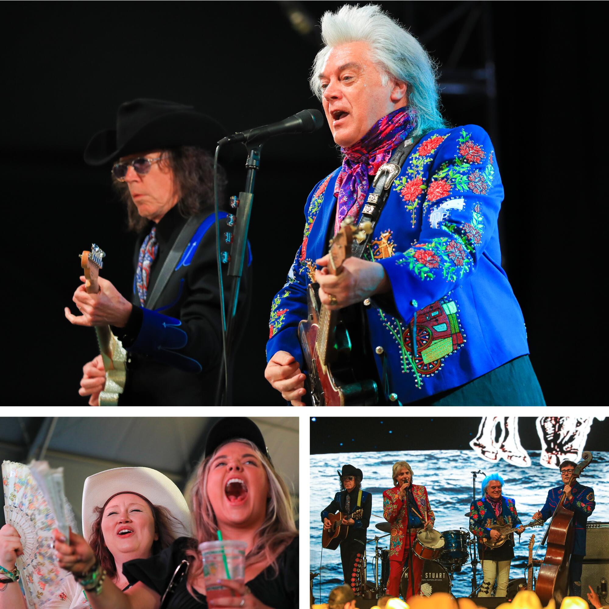 Two men play guitar onstage. One of them is in a bright blue jacket with flowers on it.