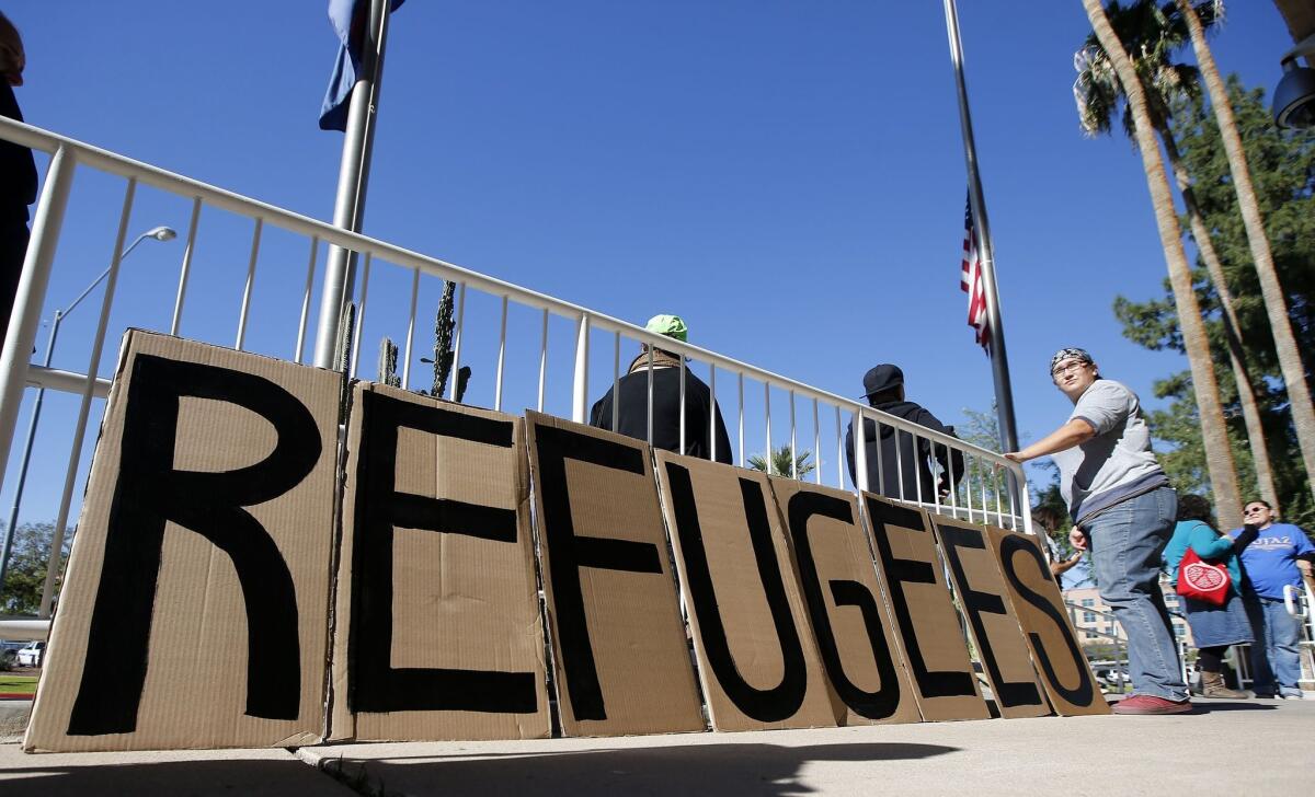 A sign welcoming Syrian refugees is placed at the entrance to the office of the Arizona governor during a rally at the Arizona Capitol Nov. 17 in Phoenix.
