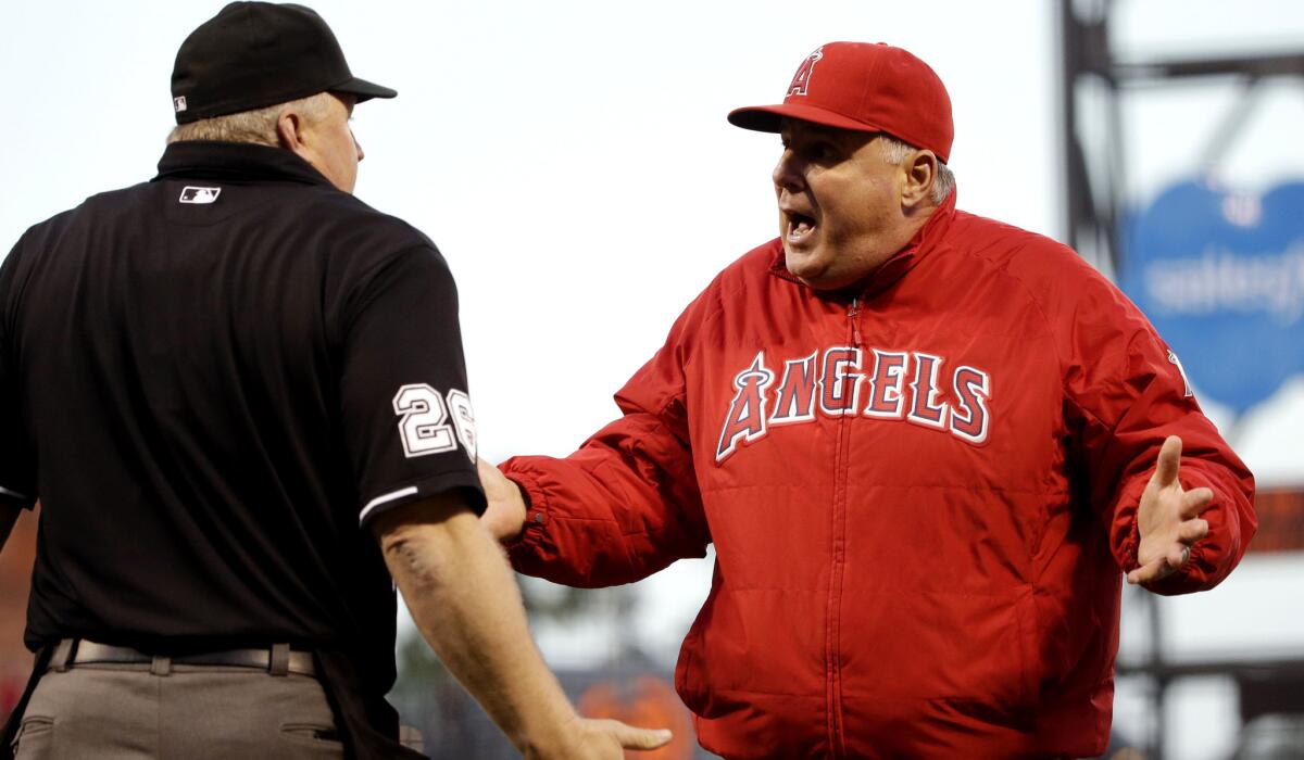 Angels Manager Mike Scioscia argues a call with home plate umpire Bill Miller in the third inning of Friday night's game against the Giants.