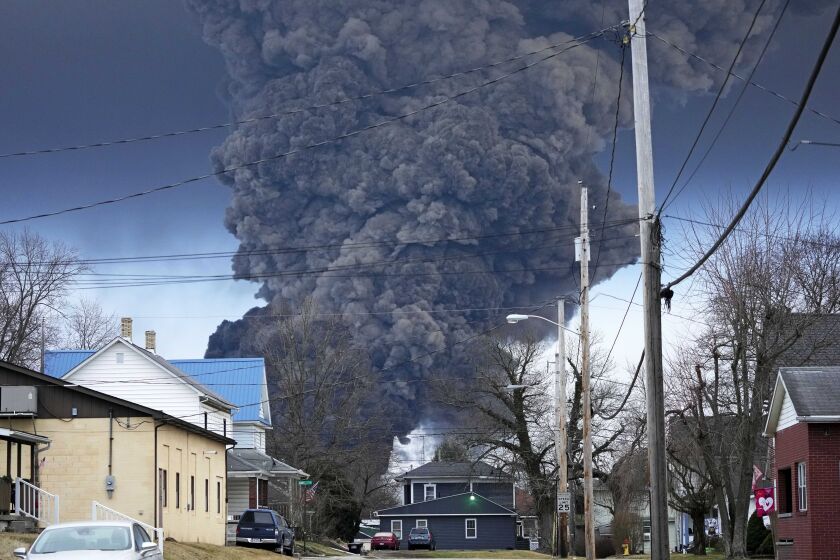 FILE - A black plume rises over East Palestine, Ohio, as a result of a controlled detonation of a portion of the derailed Norfolk Southern trains, Feb. 6, 2023. The Ohio attorney general said Tuesday, March 14, that the state filed a lawsuit against railroad Norfolk Southern to make sure it pays for the cleanup and environmental damage caused by a fiery train derailment on the Ohio-Pennsylvania border last month. (AP Photo/Gene J. Puskar, File)