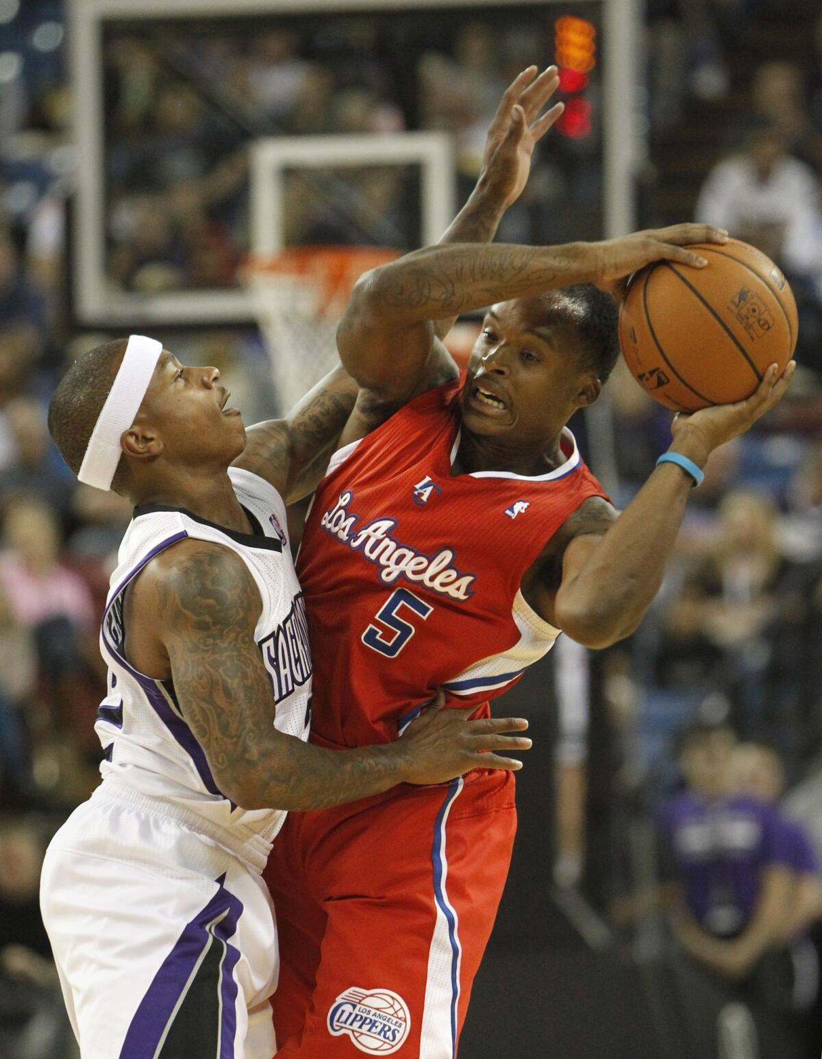 Clippers guard Maalik Wayns, right, is pressured by Sacramento guard Isaiah Thomas during the first quarter of the Clippers 99-88 preseason loss Monday.