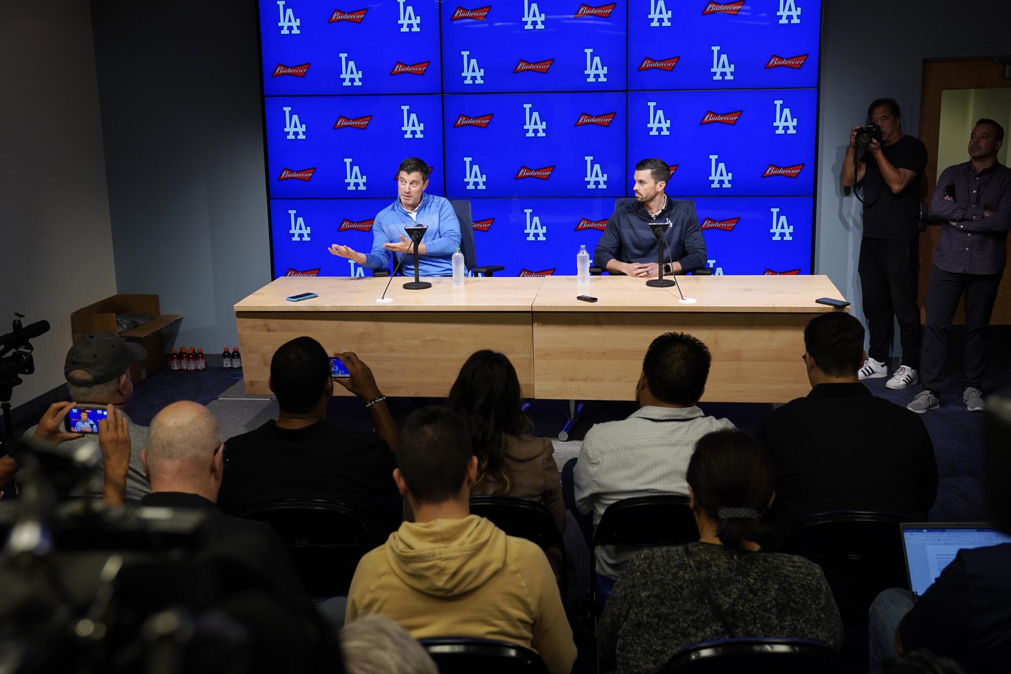 Dodgers President of Baseball Operations Andrew Friedman, left, and GM Brandon Gomes at a news conference in 2022.