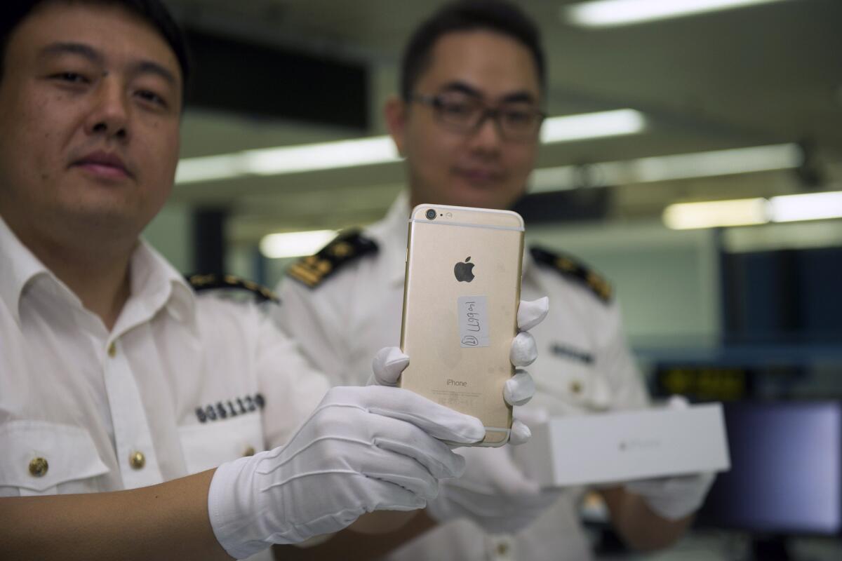 Chinese authorities display illegal iPhone 6 phones in Shenzhen on Sept 23.