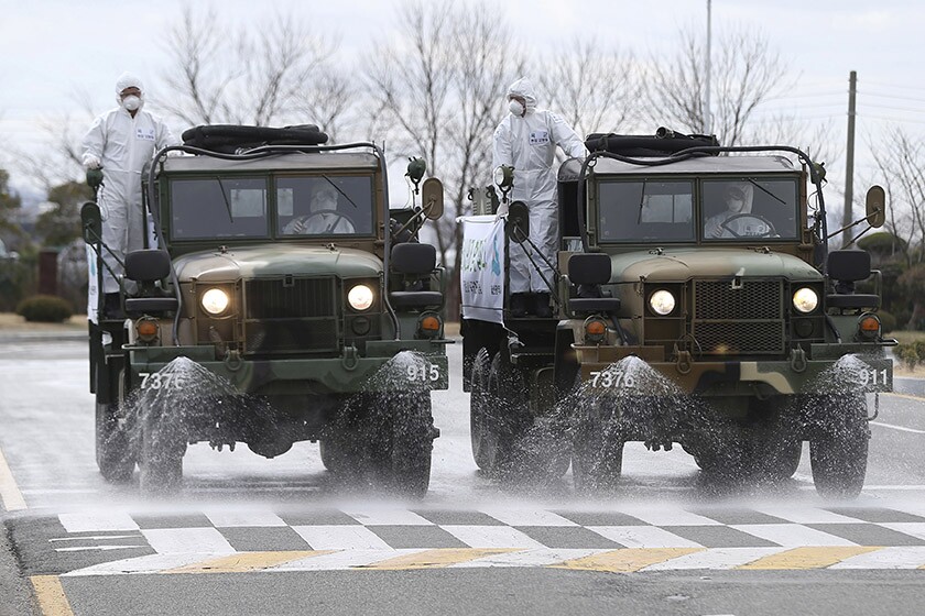 Disinfectant is sprayed on a street in Ulsan, South Korea, on Tuesday.