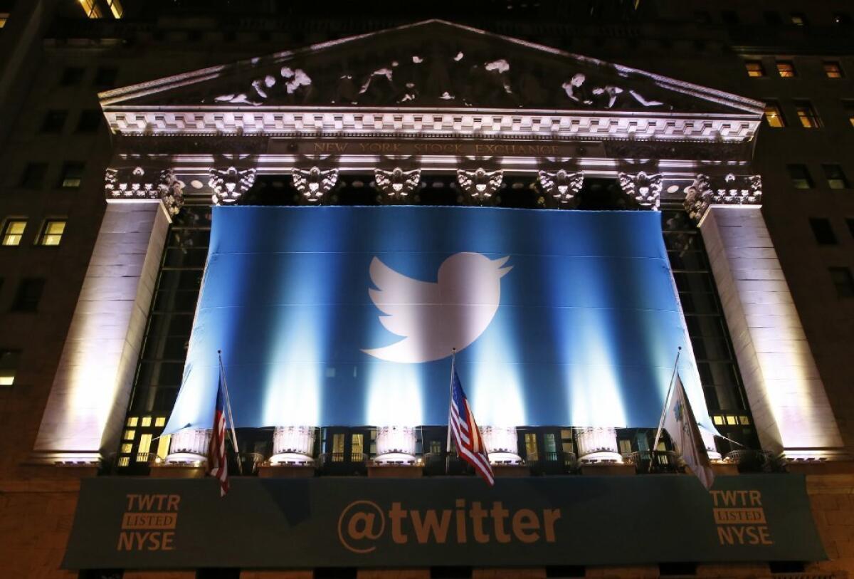 Twitter banners adorn the facade of the New York Stock Exchange the night before the company's shares start trading on the exchange.