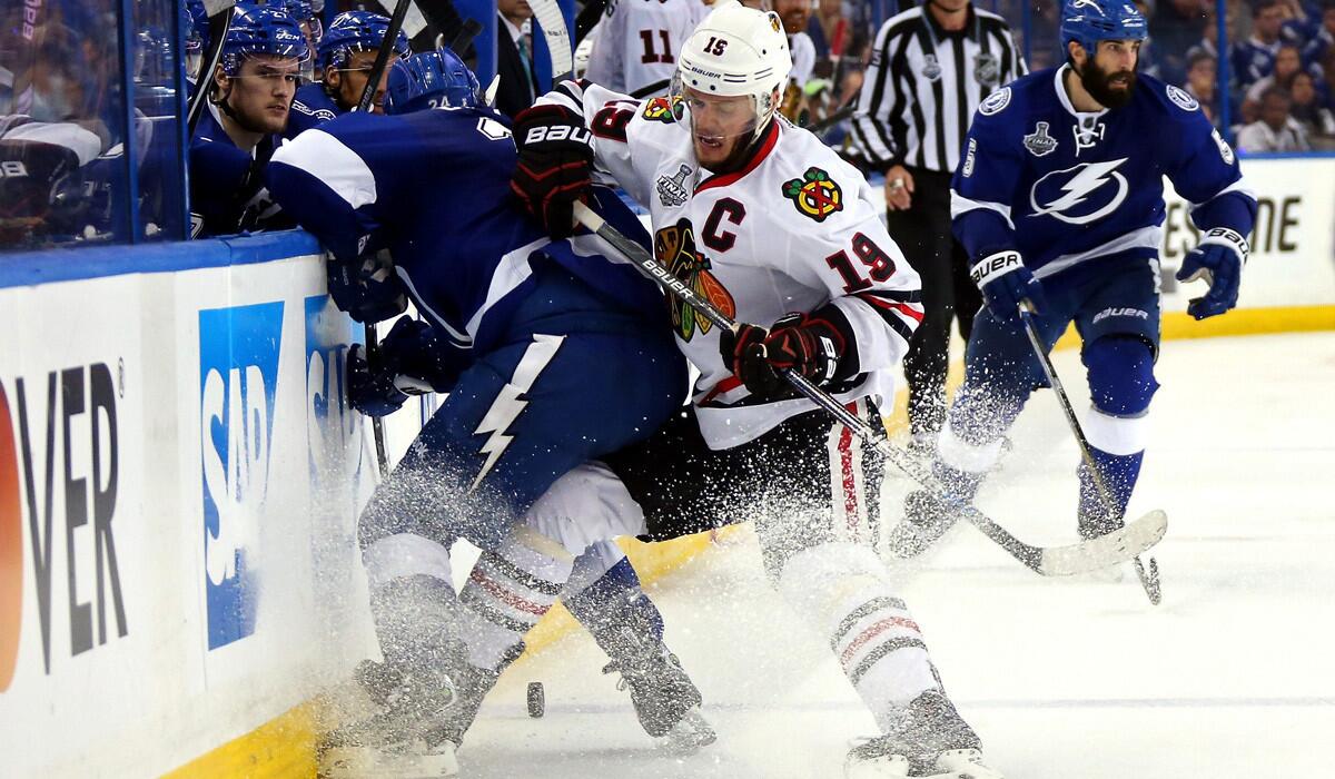 Chicago Blackhawks Jonathan Toews fights for the puck against Tampa Bay Lighting Ryan Callahan during Game Five of the Stanley Cup Final on Saturday.