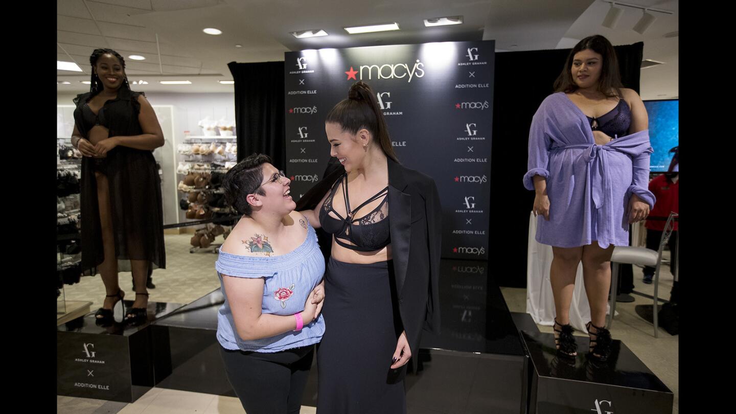 Cassandra Rodriguez, center left, of Santa Ana talks with model and designer Ashley Graham at Macy's at South Coast Plaza in Costa Mesa as Graham appeared at the store Thursday to promote her latest lingerie collection.