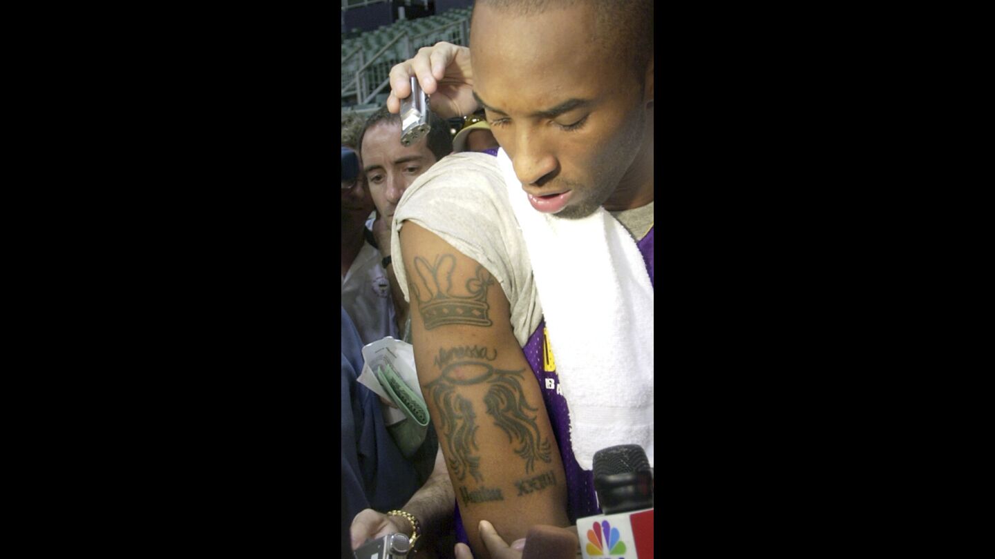 Kobe Bryant displays a tattoo he describes as a tribute to wife, Vanessa, in October 2003.