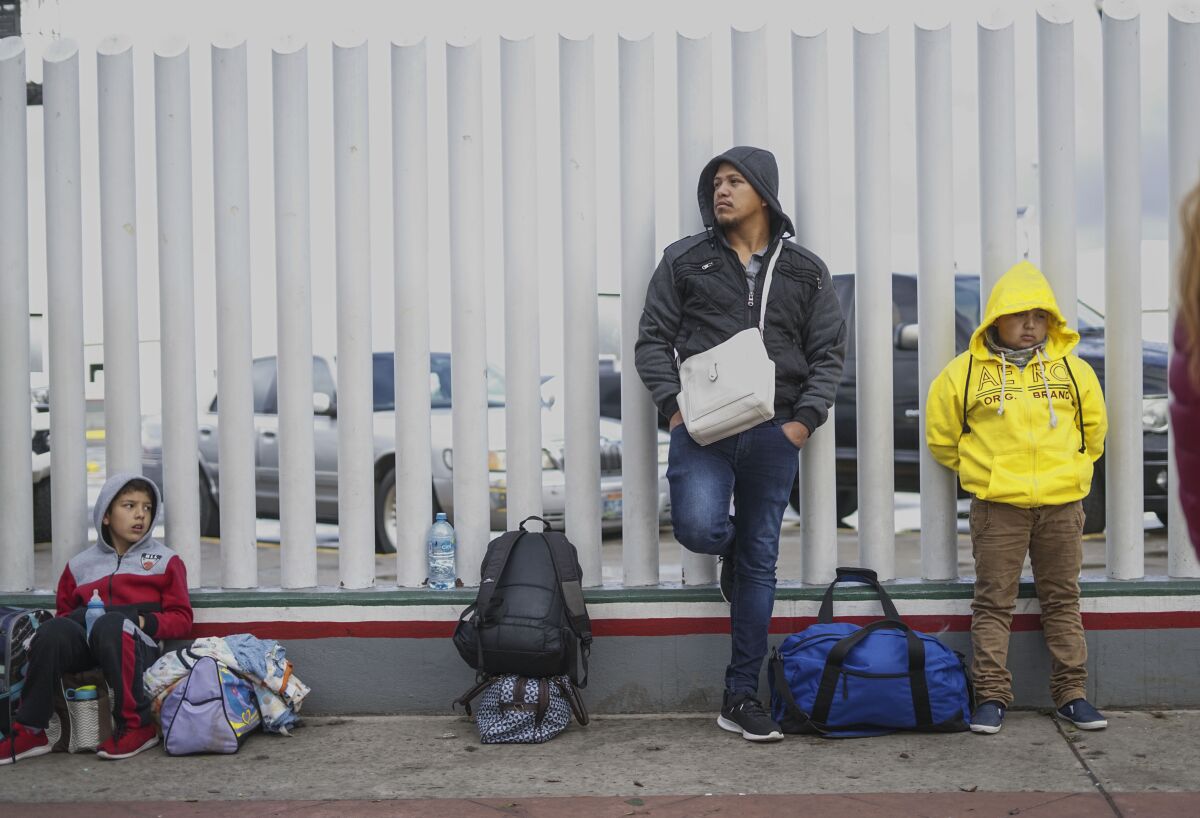 Honduran asylum seekers wait in line at the El Chaparral border crossing on March 2, 2020 in Tijuana, Mexico.