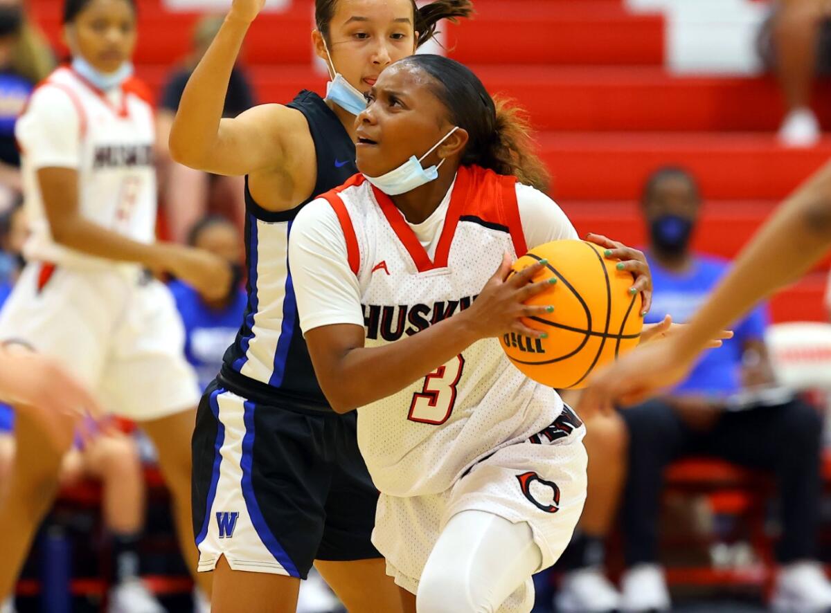 Londynn Jones of Corona Centennial drives against Windward.