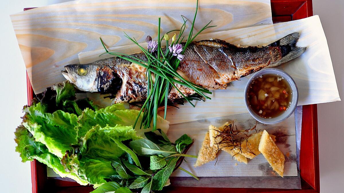Whole allium-stuffed loup de mer with a glazed skin of Red Boat fish sauce caramel and pineapple fish sauce.