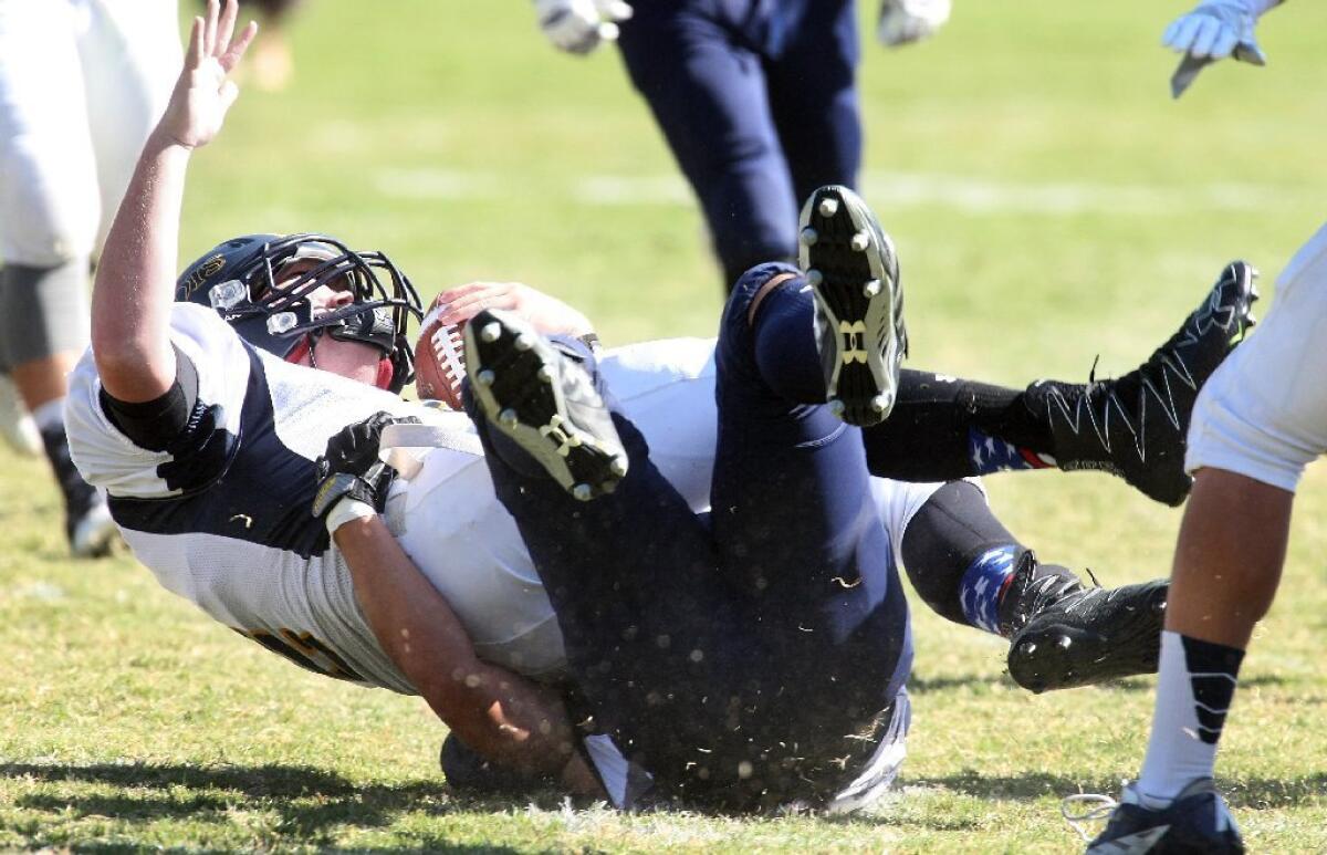 Flintridge Prep's Justin Yu sacks Hillcrest Christian quarterback Ryan Hagge during the Rebels' 78-12 victory.