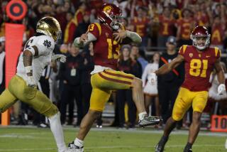 USC quarterback Caleb Williams runs into the end zone while carrying the ball against Notre Dame in 2022