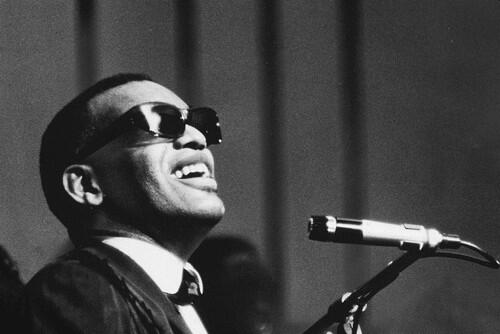 Musician Ray Charles performing at a microphone, c. 1960. (Photo by Express Newspapers/Getty Images)