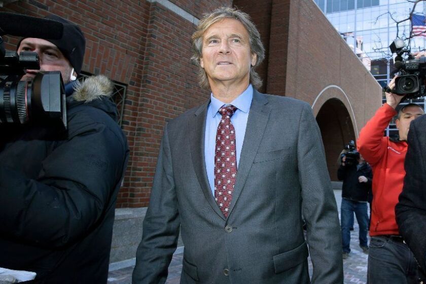 Jovan Vavic, former USC water polo coach, departs federal court in Boston on Monday, March 25, 2019, after facing charges in a nationwide college admissions bribery scandal. (AP Photo/Steven Senne)