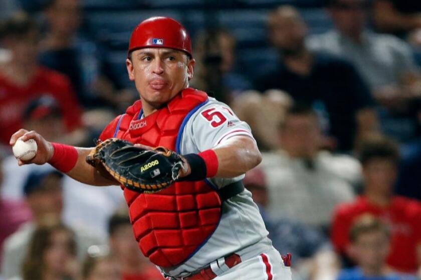 Philadelphia catcher Carlos Ruiz throws out an Atlanta baserunner during a game on July 28.