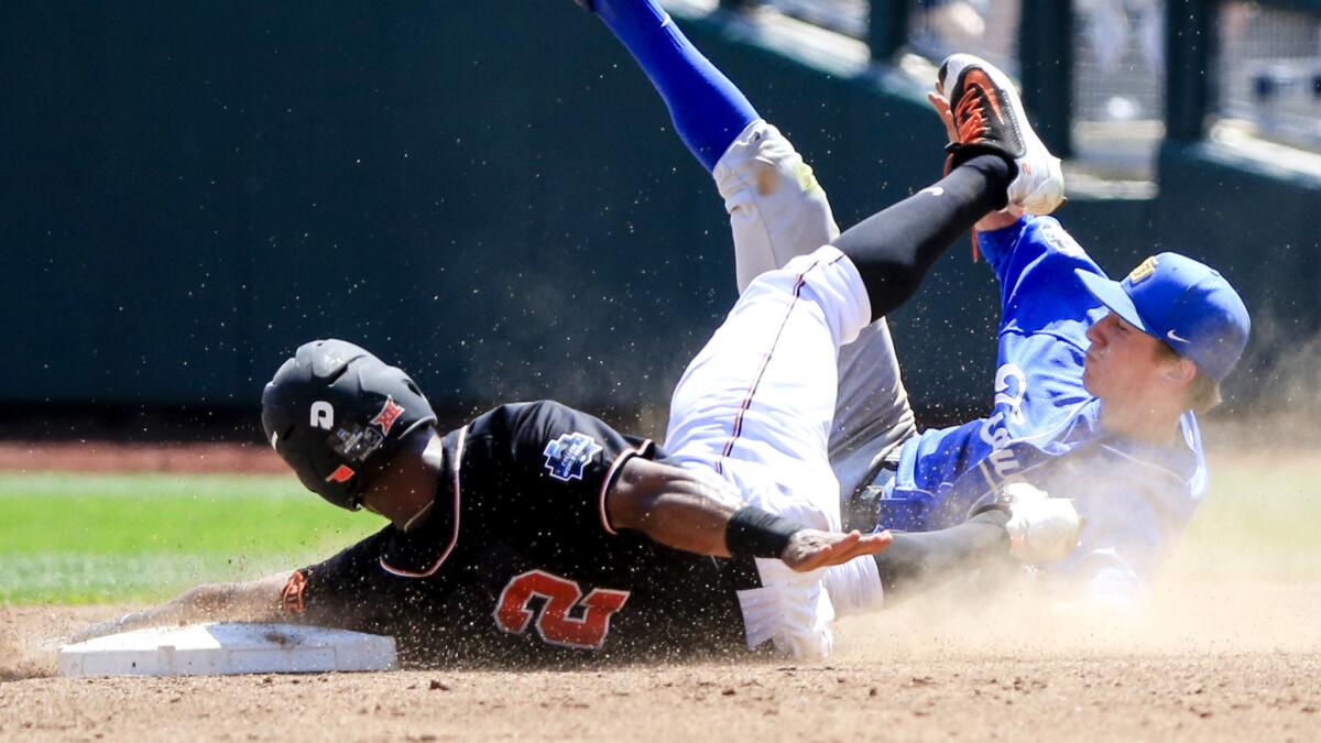 UC Santa Barbara shortstop Clay Fisher tags out Oklahoma State's J.R. Davis (2) on a steal attempt in the third inning Saturday.