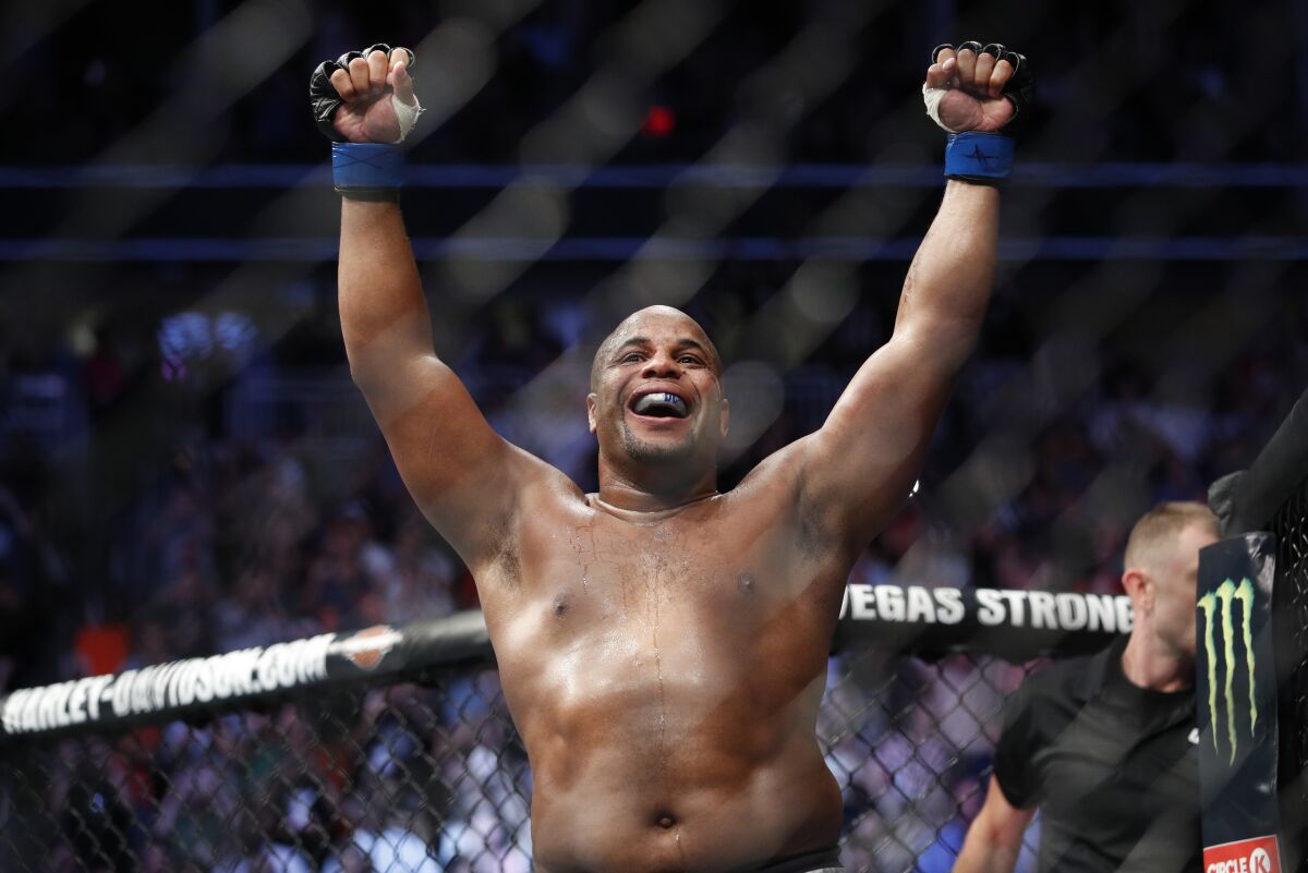 FILE - In this July 7, 2018, file photo, Daniel Cormier celebrates after defeating Stipe Miocic in a heavyweight title mixed martial arts bout at UFC 226 in Las Vegas. Cormier always told his wife he wouldn't fight past 40, even when the UFC heavyweight champion knew he could still beat everybody. Cormier extended his self-imposed deadline a bit for a rematch with Stipe Miocic at UFC 241 on Saturday, Aug. 17, 2019, but he still isn't sure how he'll replace the thrill of competition after he finally walks away. (AP Photo/John Locher, File)