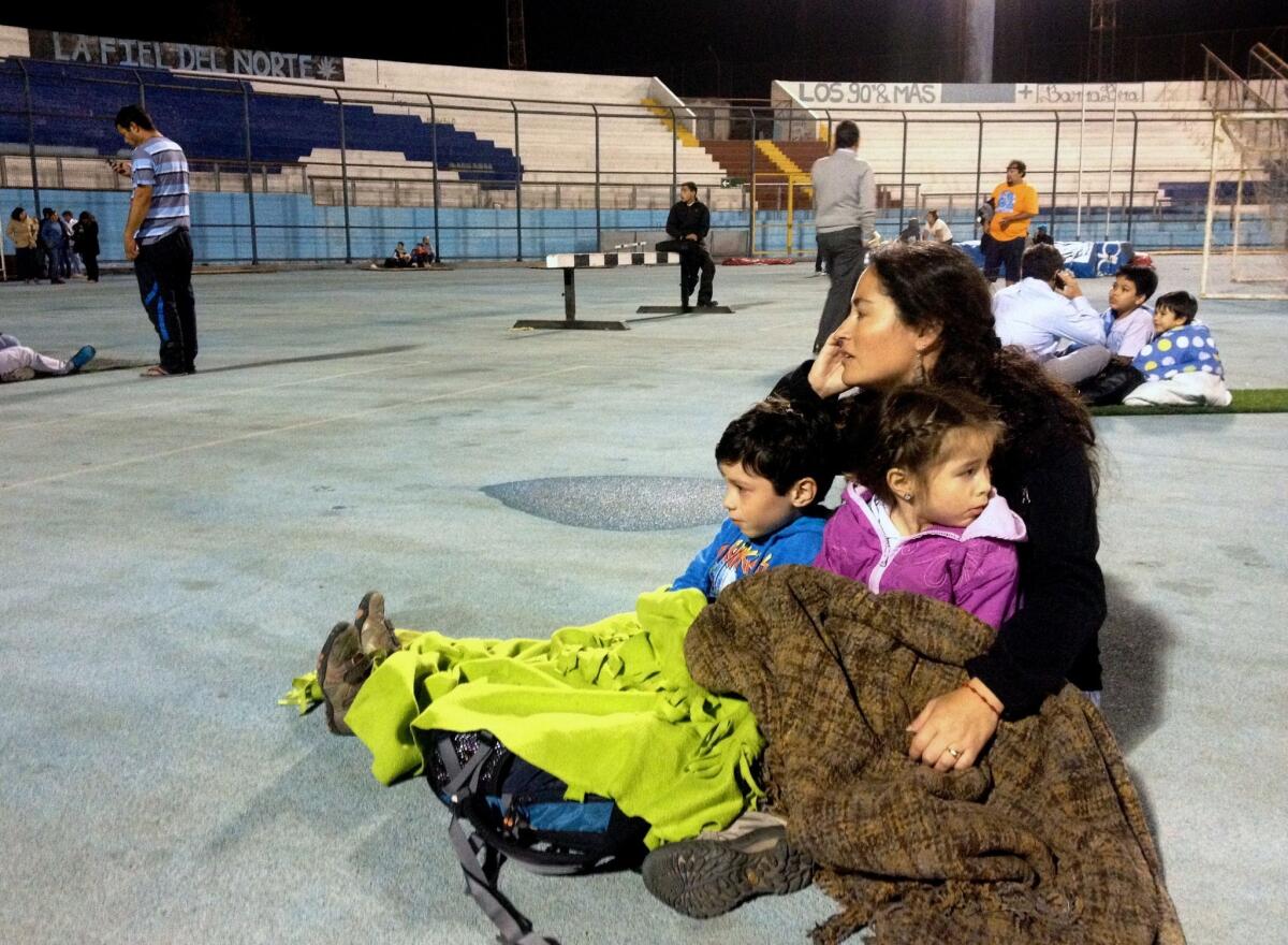 Iquique locals take refuge in the city stadium after a powerful earthquake prompted a tsunami warning for much of Latin America's Pacific coast.