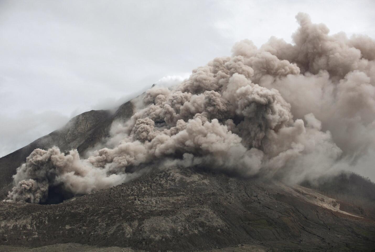 Mount Sinabung releases pyroclastic flows as seen from Tiga Serangkai, North Sumatra, Indonesia on Friday, June 12, 2015. The volcano has sporadically erupted since 2010 after being dormant for 400 years.
