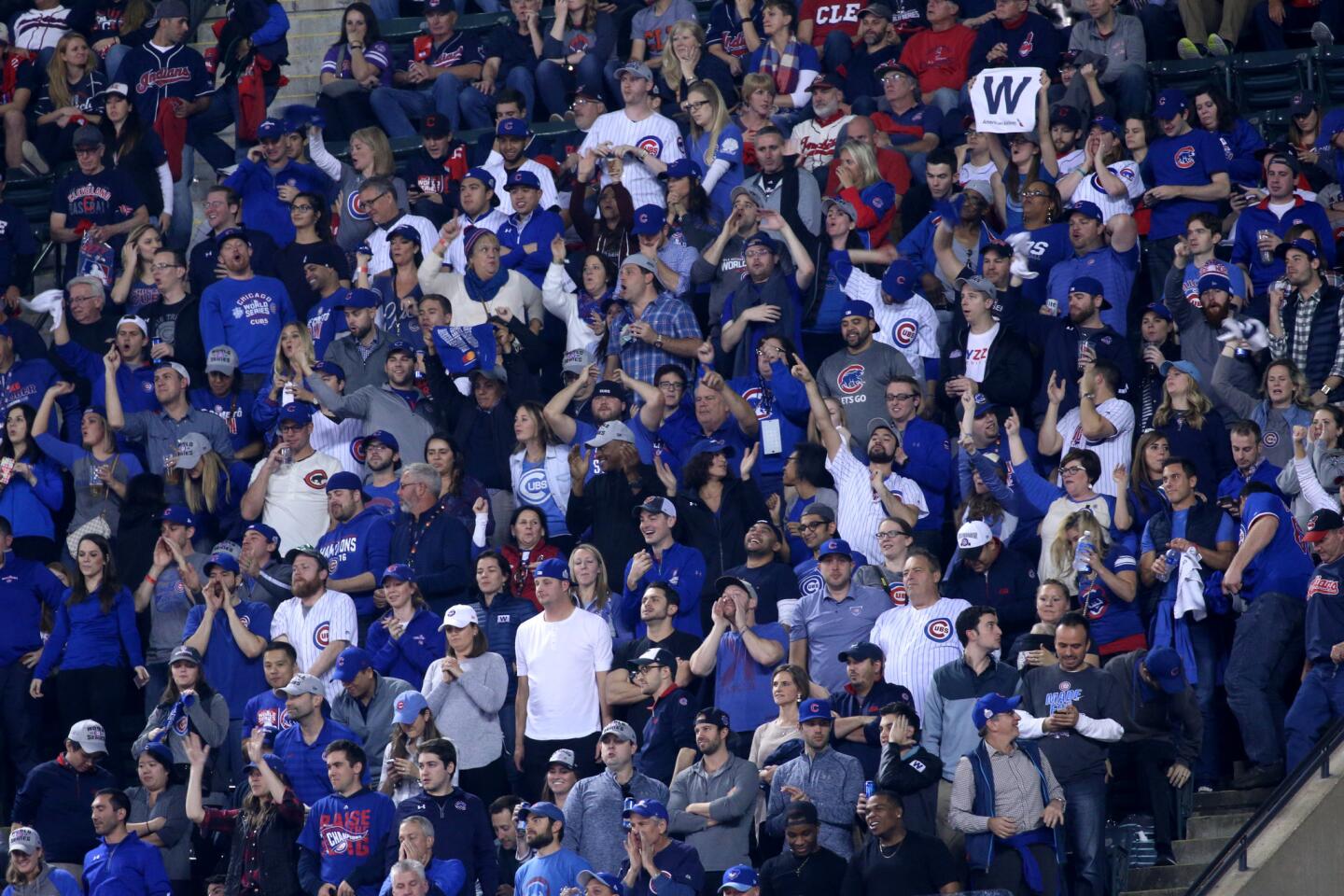 Chicago Cubs fans celebrate after first baseman Anthony Rizzo (44) hit a two-run home run in the ninth inning of Game 6 of the World Series on Nov. 1, 2016.