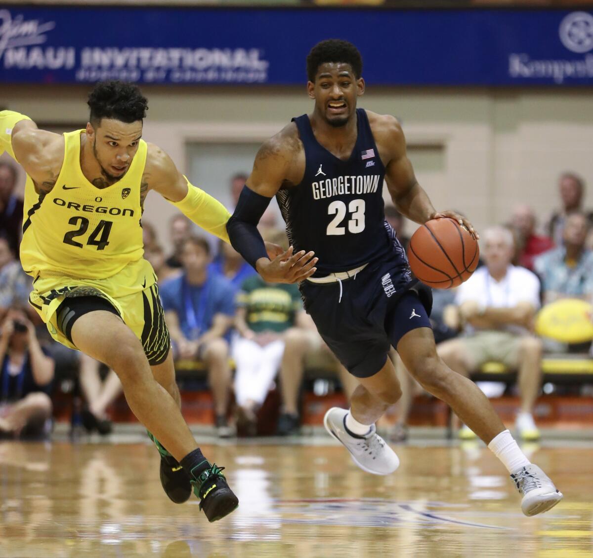 Georgetown forward Rodney Pryor (23) drives past Oregon forward Dillon Brooks (24) during the second half of a Maui Invitational game at the Lahaina Civic Center on Nov. 21.