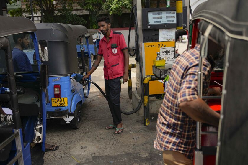 A man fills gas into a vehicle at a fuel station in Colombo, Sri Lanka, Wednesday, March 29, 2023. Sri Lanka’s government has announced reduction in fuel prices, the first significant relief to the public after a year of shortages and skyrocketing prices amid the country’s worst economic crisis. (AP Photo/Eranga Jayawardena)