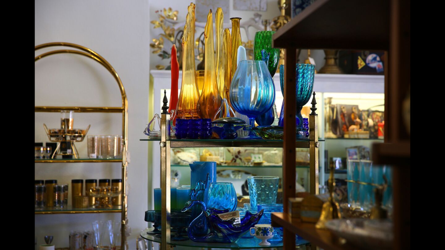 A display of colored glass from the 1950s and 1960s, including Murano and Blenko pieces, at Past & Present: Retroda.