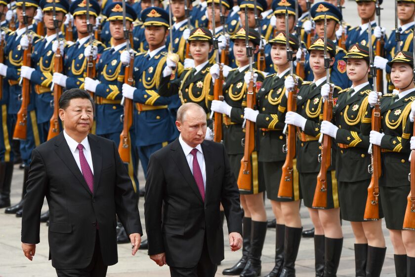 Russia's President Vladimir Putin, center, and Chinese President Xi Jinping in Beijing