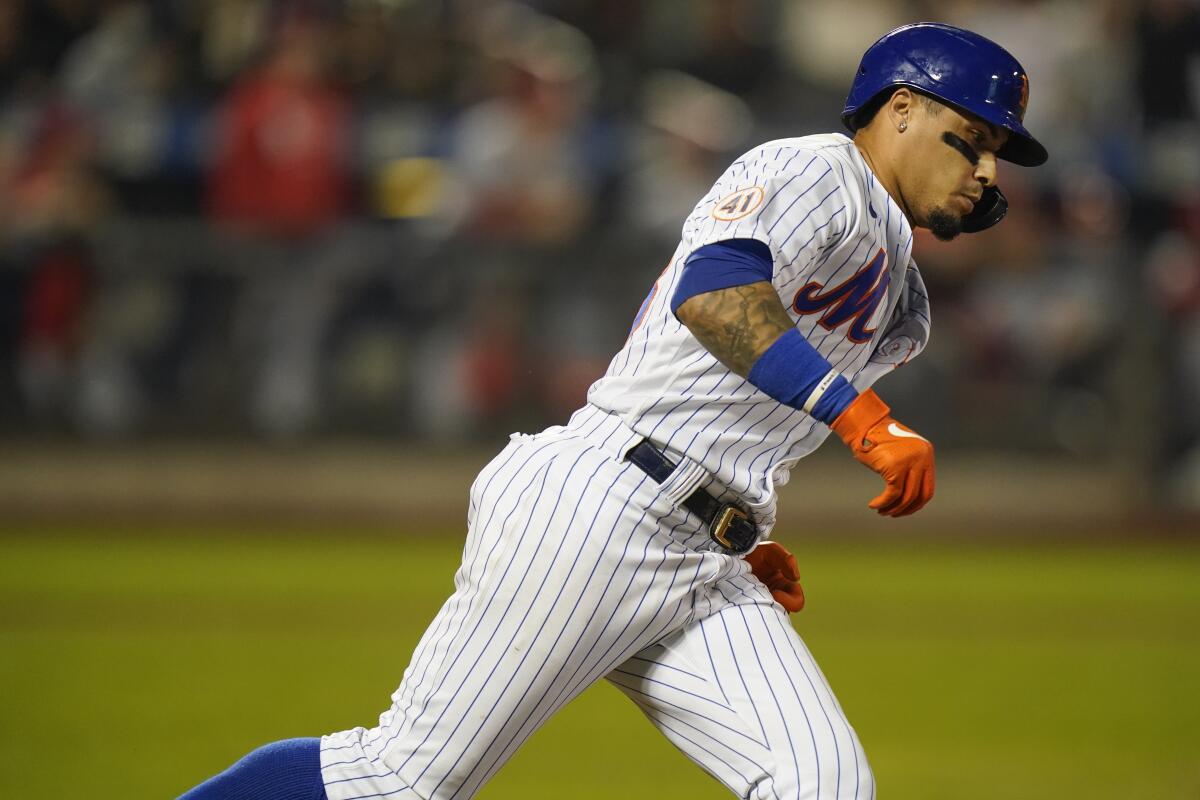 New York Mets' Javier Baez (23) runs the bases after hitting a home run.