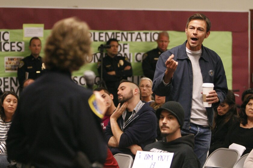 Joshua Funn confronts San Diego Police Chief Shelley Zimmerman about racial profiling by police officers during a town hall meeting by Zimmerman at Cherokee Point Elementary School in City Heights on Wednesday.