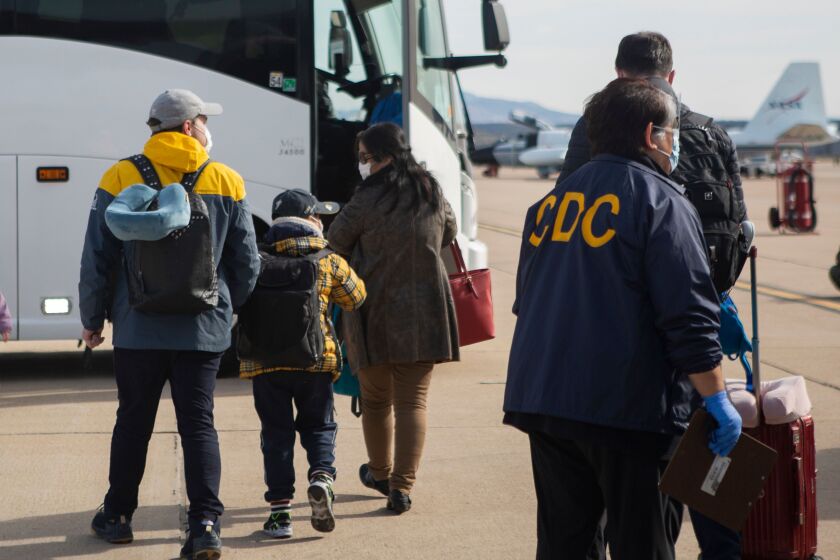 This handout photo released by the US Marine Corps shows evacuees from China arriving at Marine Corps Air Station (MCAS) Miramar, in San Diego, California, on February 5, 2020. - MCAS Miramar worked with the Center for Disease Control (CDC) and Health and Human Services (HHS) for the quarantine of travelers evacuating from China and the Coronavirus outbreak. Authorities in China warned they faced a severe shortage of hospital beds and equipment needed to treat a growing number of patients stricken by the new coronavirus, as the death toll passed 560 on February 6 and cities far from the epicentre tightened their defences. (Photo by Krysten HOUK / US MARINE CORPS / AFP) / RESTRICTED TO EDITORIAL USE - MANDATORY CREDIT "AFP PHOTO / US MARINE CORPS / LANCE CPL. KRYSTEN HOUK " - NO MARKETING - NO ADVERTISING CAMPAIGNS - DISTRIBUTED AS A SERVICE TO CLIENTS (Photo by KRYSTEN HOUK/US MARINE CORPS/AFP via Getty Images) ** OUTS - ELSENT, FPG, CM - OUTS * NM, PH, VA if sourced by CT, LA or MoD **