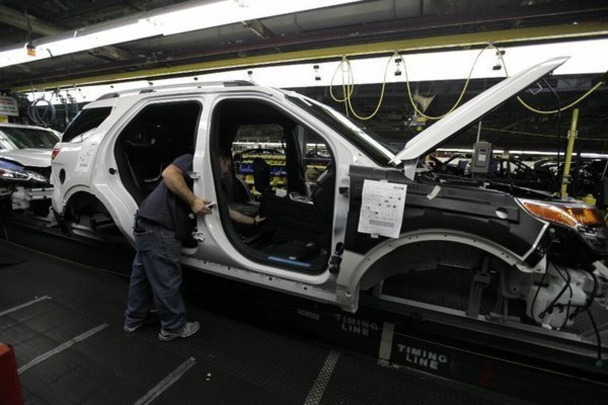 Ford workers build an Explorer SUV at the automaker's Chicago Assembly Plantin 2010.