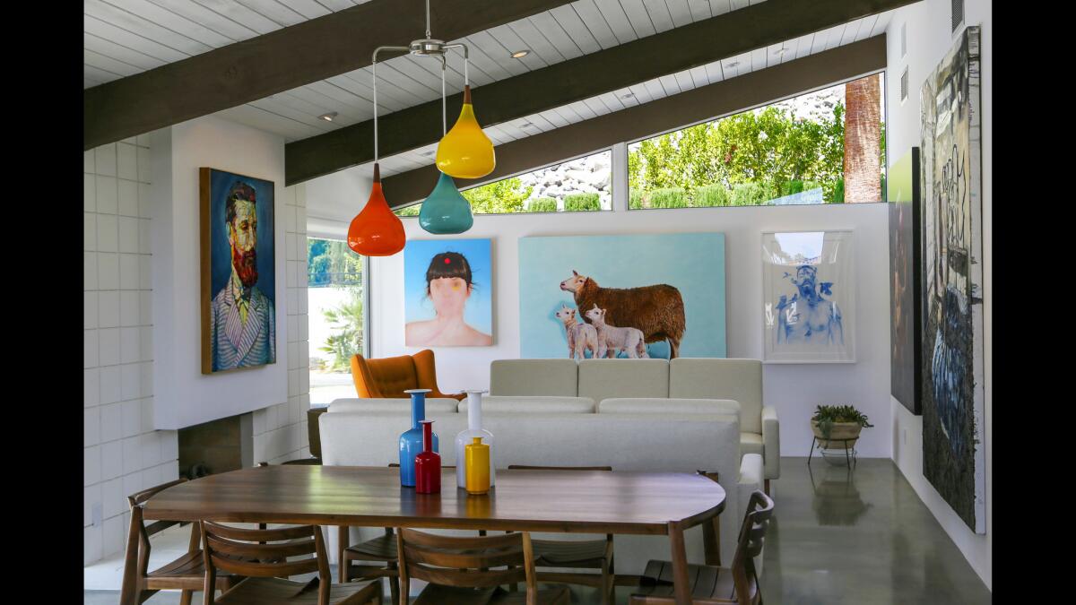 The addition of clerestory windows on the westward facing side of the house offer eye-catching views of the San Jacinto Mountains from the living room, shown here, master bedroom and bath. A colorful Danish glass pendant in the dining room by Holmegaard reflects the vibrant colors of the surrounding artwork.