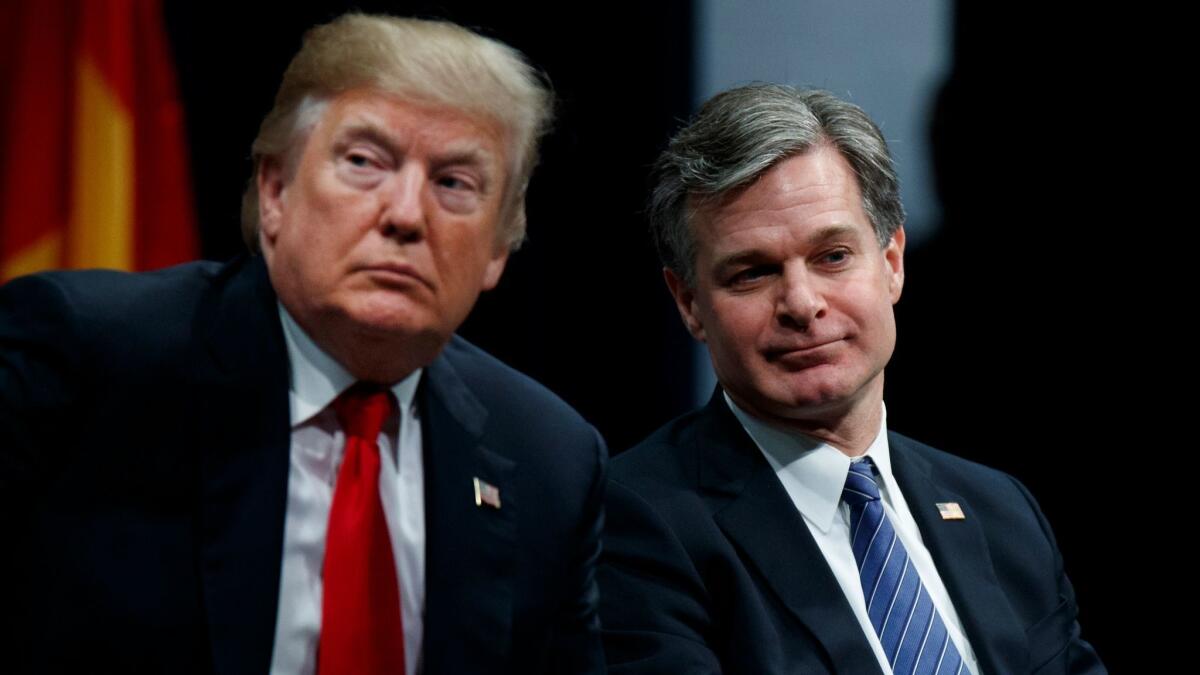 President Donald Trump sits with FBI Director Christopher Wray during the FBI National Academy graduation ceremony, Friday, Dec. 15, 2017, in Quantico, Va. (AP Photo/Evan Vucci)