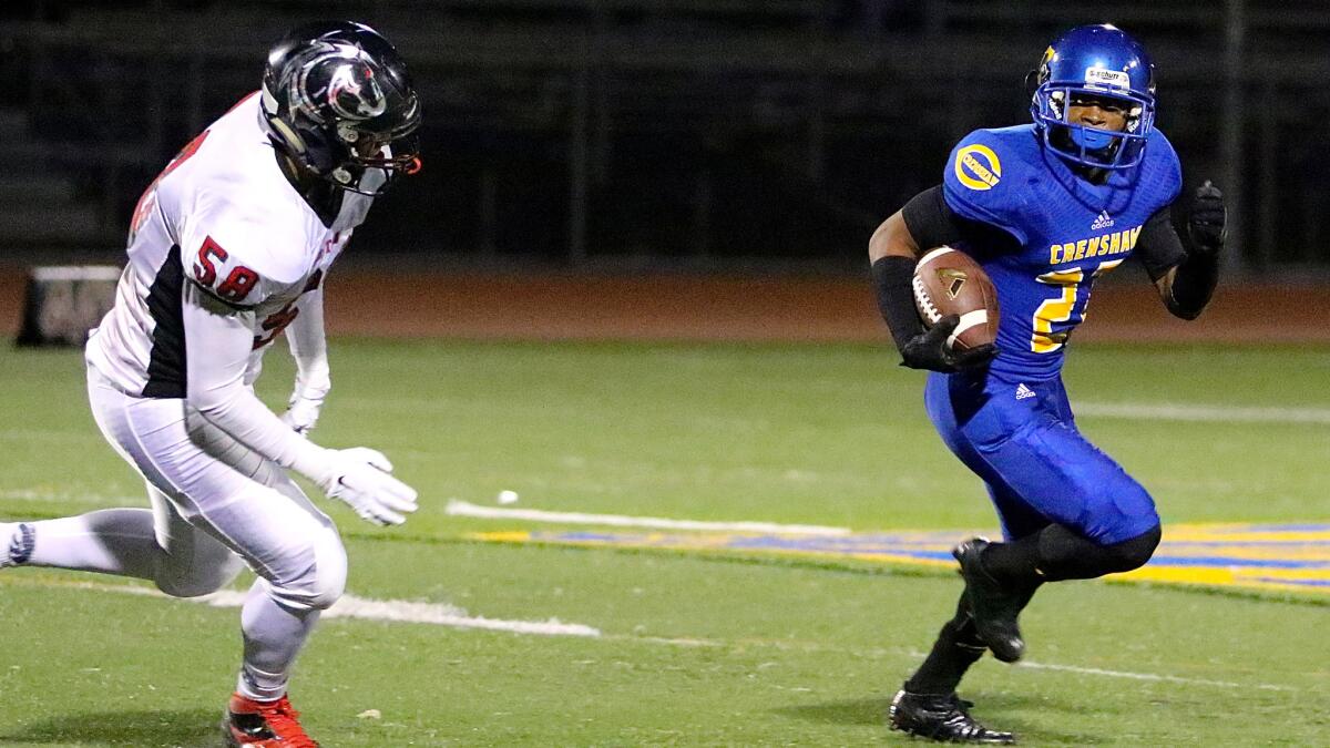 Crenshaw running back Aundre Carter is pursued by Arleta defensive end Shaunn Freire in the second quarter of Friday's City Section Division I semifinal.